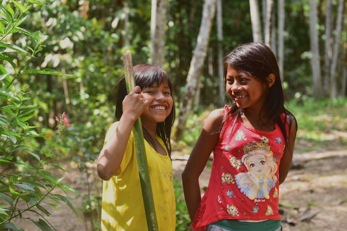Two children smiling in the forest