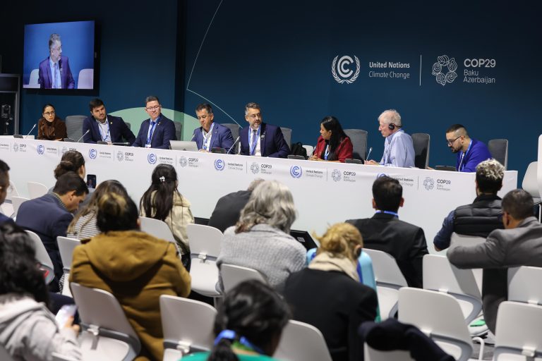 people seated at table at an official meeting
