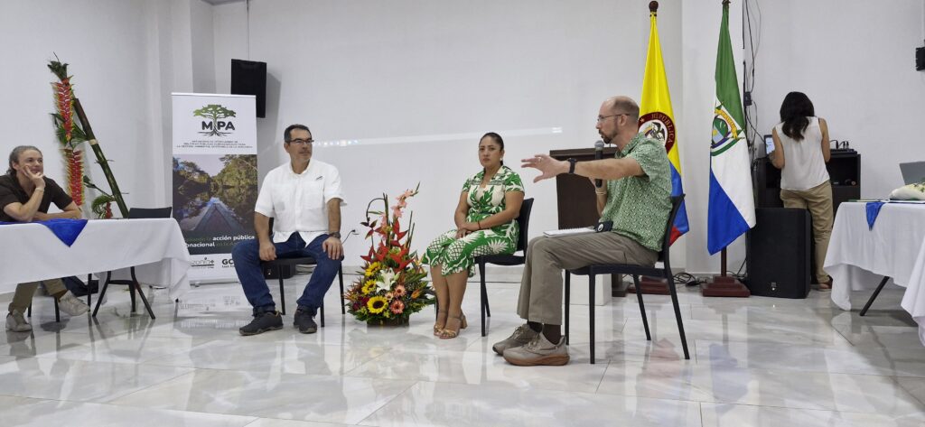 Man with microphone at MIPA panel discussion
